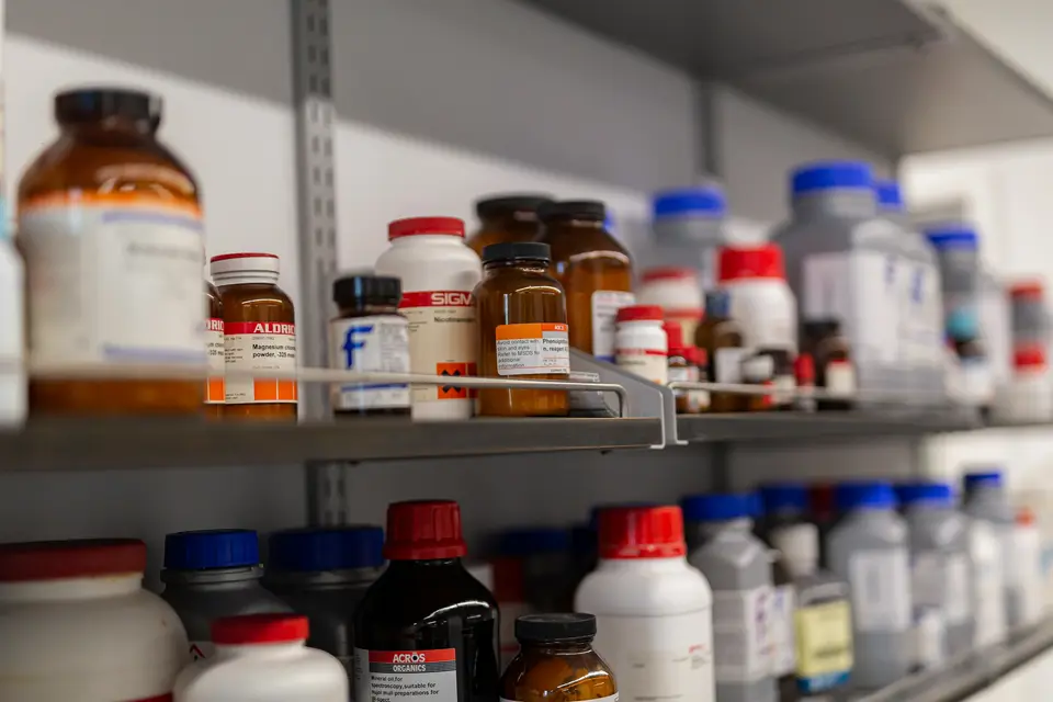 Shelves of labelled amber and white reagent bottles